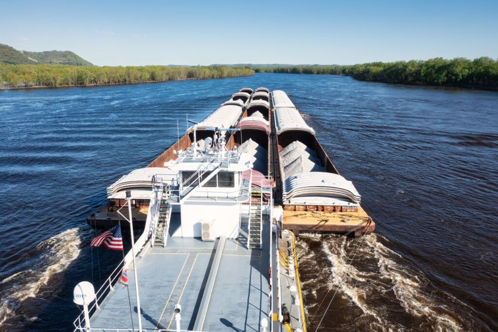 Cargo barge transporting goods on the Mississippi River near Wabasha, Minnesota.